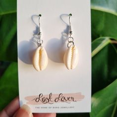 Our new Coastal Cowrie Shell Earrings are individually handmade and inspired by the ocean. Made from Cowrie shells and silver ear hooks, these boho beauties bring a touch of coastal magic to your look, perfect for those who adore bohemian beach jewellery. Product Highlights: 1. Cowrie Shells: Handcrafted with delicate Cowrie shells, these earrings embody the spirit of the ocean. 2. Coastal Boho Chic: Infuse your style with seaside charm, a perfect addition to your bohemian ensemble. 3. Handcraft Sterling Silver Earrings For Summer Beach, Silver Earrings For Summer Vacation, Sterling Silver Hoop Earrings For Summer, Handmade Beachy Dangle Jewelry, Beachy Handmade Dangle Jewelry, Handmade Coastal Jewelry For Summer, Handmade Sterling Silver Earrings For Summer, Bohemian Drop Earrings For Beach Season, Handmade Beachy Earrings For Summer