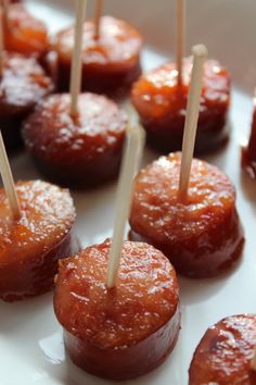 small appetizers with toothpicks in them on a white plate