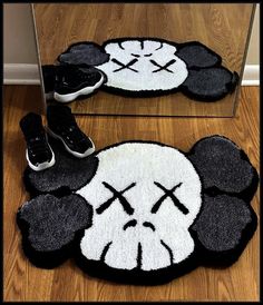 a pair of shoes sitting on top of a rug in front of a mirror next to a pair of sneakers