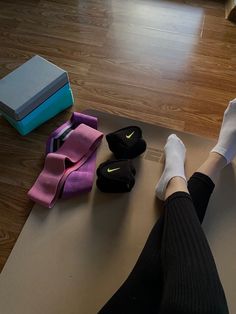 a person sitting on a yoga mat with their feet propped up