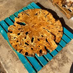 a wooden table sitting on top of a blue chair