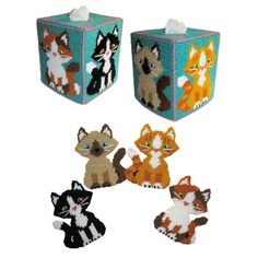 four little kittens are sitting together on the tissue dispenser holder set