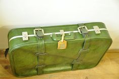 "Vintage suitcase, Green suitcase, Green luggage bag, Big travel bag, green baggage Very beautiful vintage suitcase in green leather imitation and gray inlay inside. In beautiful vintage condition with some small traces of use, please see photos. There is only one compartment, no pockets. Strings inside are only for decor, not for use. It closes and opens with ease, two lockers and no key. With your name tag. Your new trustful travel companion or gorgeous home decorating item. Dimensions: 27\" l Green Suitcase, Big Travel Bag, Green Luggage, Big Suitcases, Old Suitcases, Vintage Suitcase, Vintage Luggage, Green Suit, Bag Green