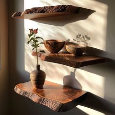 two wooden shelves with bowls and vases on them