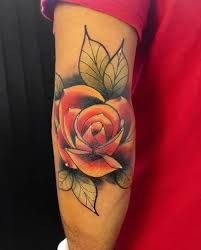 a man with a rose tattoo on his arm