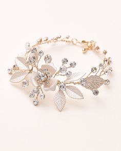 Soft florals & shimmering crystals make our Kacie Floral Bridal Bracelet the perfect accent to your wedding day style. Crafted with petals & round gemstones, you'll want to wear Kacie again & again, long after you say 'I do.' Kacie is available in silver & gold, and beautifully lightweight. Elegant Leaf-shaped Wedding Jewelry, Elegant Adjustable Leaf-shaped Jewelry, Silver Leaf-shaped Jewelry For Party, Silver Leaf-shaped Adjustable Jewelry, Leaf-shaped Metal Party Jewelry, White Metal Crystal Bracelet For Wedding, Gold Leaf-shaped Jewelry For Wedding, Adjustable Gold Leaf-shaped Jewelry, Leaf-shaped Gold Jewelry For Wedding