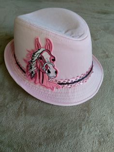 KyDerby Ladies pink fedora hat with  Pink and black horse embroidered applique and pink sequins accented with black satin. Kentucky derby Barbie pink! Photo shoot. Perfect for that breast cancer awareness walk too!! Cancer Survivor fedora! Coordinating pink and black mens pretied bow tie available separately.  #fedorahat #fedora #hat #topifedora #fashion #hats #topifedoramurah #fedorahats #style #topilaken #hatmaker #hatshop #topicustom #porkpiehat #fedoraimport #topilakenimport #porkpie #topi #fedorafashion #vintagehat #hatter #topipantai #jualtopi #hatstyle #hatlovers #handmadehat #fedorahatmurah #fedorastyle #topipantaimurah #topiporkpie #whiteandblackhat #breatcancersurvivorhat #pinkhat Pink Photo Shoot, Pink Fedora Hat, Pink Fedora, Fedora Fashion, Pink Horse, Pork Pie Hat, Pink Photo, Embroidered Applique, Pink Hat