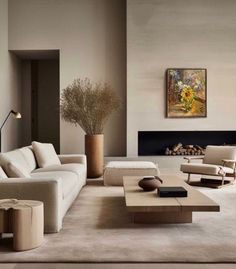 a living room filled with furniture and a large painting on the wall above it's fireplace