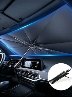 the inside of a car with an open umbrella on it's dash board and dashboard