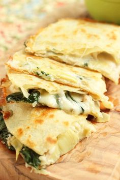 there is a tortilla with spinach and cheese on it