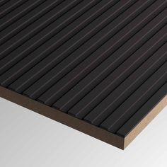 a close up view of the top of a black and brown plastic slatted surface