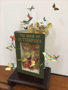 the book of butterflies is sitting on a table