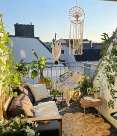 a balcony with plants and rugs on the floor