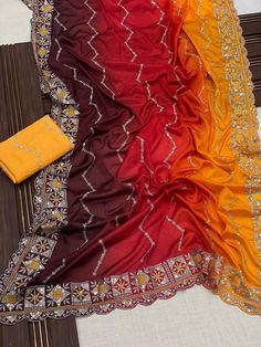 Package Contains: Saree, Blouse, Petticoat 🥻 Saree-2d Chinnon silk  👚 Blouse-Mono banglori silk 🧵 Work-Embroidery  ❤️ Beautiful chinnon silk saree with sequins embroidery work with cutwork as well as contrast color blouse with embroidery work With FREE Saree fall and Pico with matching petticoat Our Services- Stitching service is also available on customer demand. Please get in touch with us for Stitching Service. We customize everything when it comes to ethnic wear. We Provide both i.e. unst Red Silk Saree With Mirror Work, Red Silk Dupatta With Mirror Work, Orange Saree With Dori Work, Orange Designer Saree With Dori Work, Designer Orange Saree With Dori Work, Orange Traditional Wear With Resham Embroidery In Chinon, Traditional Wear In Orange With Resham Embroidery, Orange Embroidered Silk Sharara, Multicolor Silk Choli With Resham Embroidery