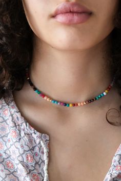 Our happy Rainbow necklace is made up of various round gemstones such as: Malachite, Firestone, Turquoise, Coral, Jade, Rose Quartz, Tigereye, Garnet, Lapis etc. and is dotted with 14k solid gold beads. The clasp is also made of 14k gold and has an extension chain to wear at different lengths. #necklace #rainbow #candynecklace #gemstonenecklace #gemstone #malachite #quartz Colorful Gemstone Beads Spiritual Jewelry, Colorful Spiritual Gemstone Beads Jewelry, Spiritual Colorful Gemstone Beads Jewelry, Colorful Gemstone Bead Jewelry, Rainbow Polished Round Bead Jewelry, Multicolor Beaded Necklaces For Meditation, Spiritual Colorful Round Beads Jewelry, Colorful Polished Beads Jewelry For Gifts, Multicolor Spiritual Jewelry With Tiny Beads