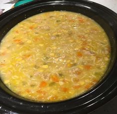 a crock pot filled with soup on top of a table