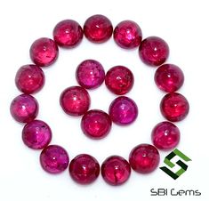 a bunch of pink beads sitting on top of a white table