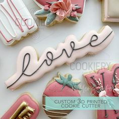 decorated cookies with the word love spelled in cursive writing