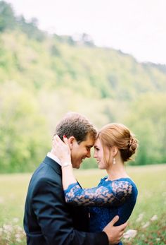 a man and woman hugging each other in a field