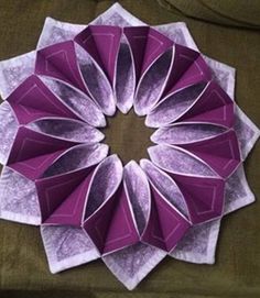 an origami flower sitting on top of a couch