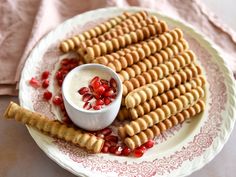 some crackers are sitting on a plate with pomegranate