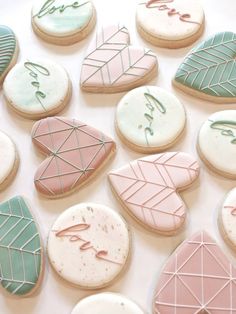 decorated cookies are arranged on a white surface