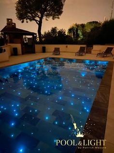 an outdoor swimming pool with blue lights