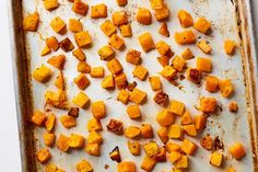 roasted sweet potatoes on a baking sheet ready to go into the oven