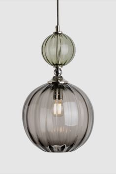 a glass light fixture hanging from the ceiling