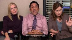 two women and a man sitting next to each other in front of an office window