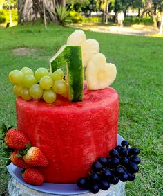 a watermelon cake with fruit on it and the number one made out of fruits