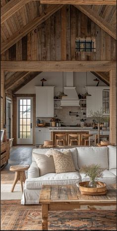 a living room filled with furniture next to a wooden ceiling covered in wood planks