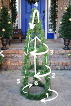 a christmas tree with arrows pointing to the top and bottom, in front of a blue door