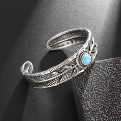 Feather Blue Turquoise Cuff Bracelet Transform Your Energy with Natural Healing Introducing our stunning Feather Blue Turquoise Cuff Bracelet, a perfect blend of beauty and healing potential. This exquisite piece not only enhances your style but also serves as a powerful tool for emotional and spiritual well-being. Key Features: Metals Type: Crafted from high-quality alloy, ensuring durability and a timeless look. Bracelet Type: Designed as a classic cuff, this bracelet adapts to any wrist size Simple Cuff Bracelet, Open Bracelet, Moda Hip Hop, Womens Cuff Bracelets, Trending Bracelets, Feather Wings, Turquoise Bracelet Cuff, Turquoise Cuff, Mens Jewelry Bracelet