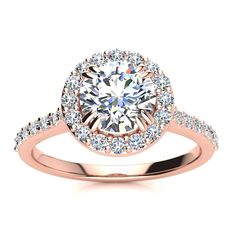 a yellow gold engagement ring with an oval cut diamond surrounded by small round brilliant diamonds