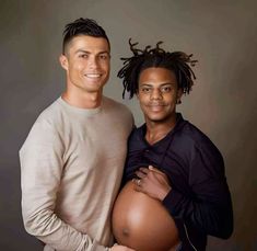 two men are posing for the camera with their pregnant belly