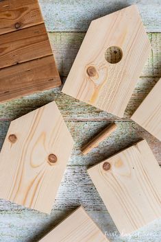 several pieces of wood sitting on top of a wooden table next to each other with holes in them