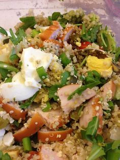 a bowl filled with rice, meat and veggies next to an egg on top