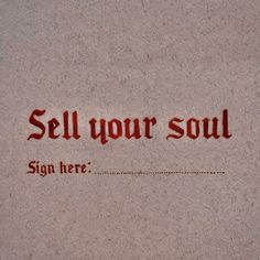 a sign that says sell your soul on the side of a wall with red writing