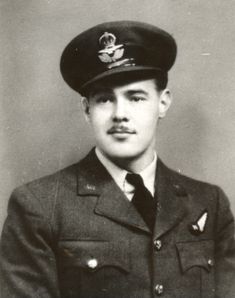 an old black and white photo of a young man in uniform, wearing a hat