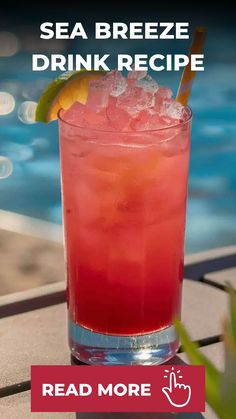 a red drink sitting on top of a table next to a swimming pool with the words sea breeze drink recipe