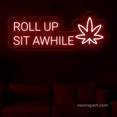 a red neon sign that says roll up sit awhie in front of a couch