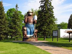 a large bear statue in the middle of a park