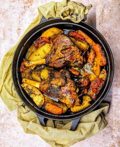 a pan filled with food sitting on top of a table next to a napkin and cloth