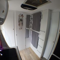 the inside of an airplane with its door open and some curtains hanging on the wall