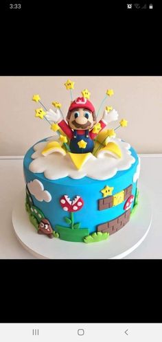 a cake that is on top of a white plate and has a mario bros figure on it