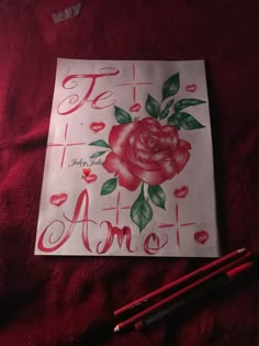 a piece of paper with some writing on it next to two pencils and a rose