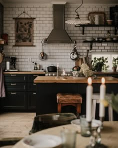 a kitchen filled with lots of counter top space and candles in front of the stove