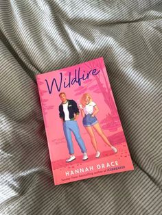 the book wildlife by hannah grace is laying on a bed