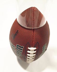 a football in a glass case on a white background